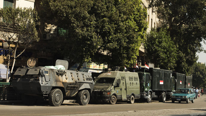 Trucks and APC's of Egyptian riot police are parked in the main street leading to Egypt's landmark Tahrir square on August 20, 2013 in Cairo, Egypt.(AFP Photo / Gianluigi Guercia)