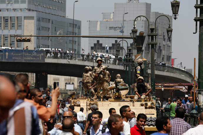 Soldiers stand guard on an armoured personnel carrier positioned outside Ramses Square, near al-Fath mosque in Cairo August 17, 2013 (Reuters / Youssef Boudlal)