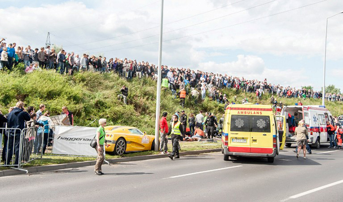 Rescue teams provide assistance to the wounded after the accident, which occurred during the auto shows Gran Turismo Polonia 2013 in Poznan on June 30, 2013. (AFP Photo / Wojciech Wloch)