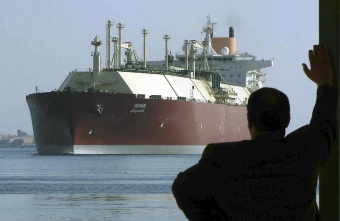 A man looks as the world's biggest Liquefied Natural Gas (LNG) tanker DUHAIL as she crosses through the Suez Canal (Reuters).
