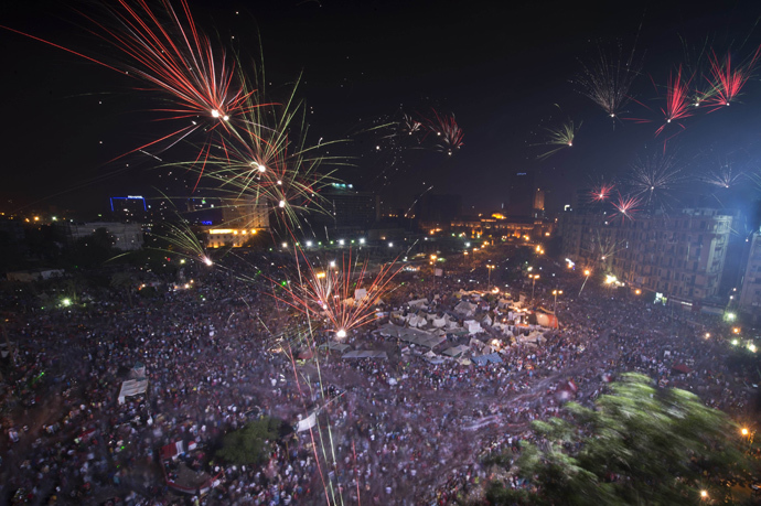 Fireworks light up the sky as Hundreds of thousands of Egyptians celebrate after Egytptian Defense Minister Abdel Fattah al-Sisi's speech announcing The Egyptian army toppling Islamist President Mohamed Morsi in Egypt's landmark Tahrir square on July 3, 2013 in Cairo, Egypt AFP Photo / Khaled Desouki) 