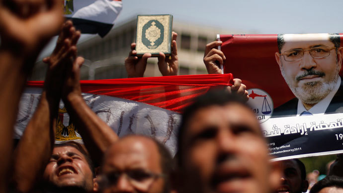Protesters, who support former Egyptian President Mohamed Morsi, with flags and posters march near Cairo University after Friday prayers in Cairo July 5, 2013.(Reuters / Suhaib Salem)