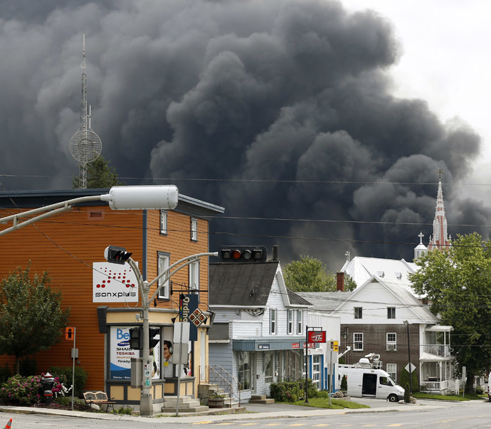 A cloud of smoke is seen over Lac Megantic after a train explosion, July 6, 2013. (Reuters/Mathieu Belanger)