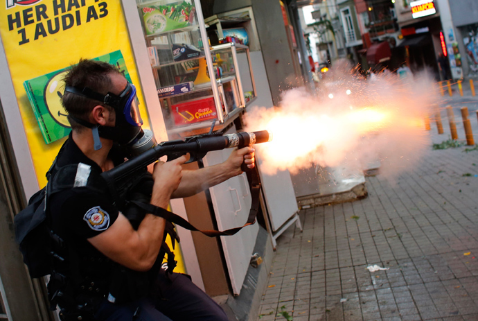 A riot policeman fires teargas during a protest in central Istanbul July 6, 2013 (Reuters / Murad Sezer)