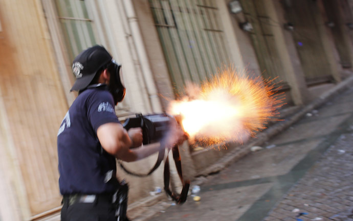 A riot policeman fires teargas during a protest in central Istanbul July 6, 2013. (Reuters/Murad Sezer)