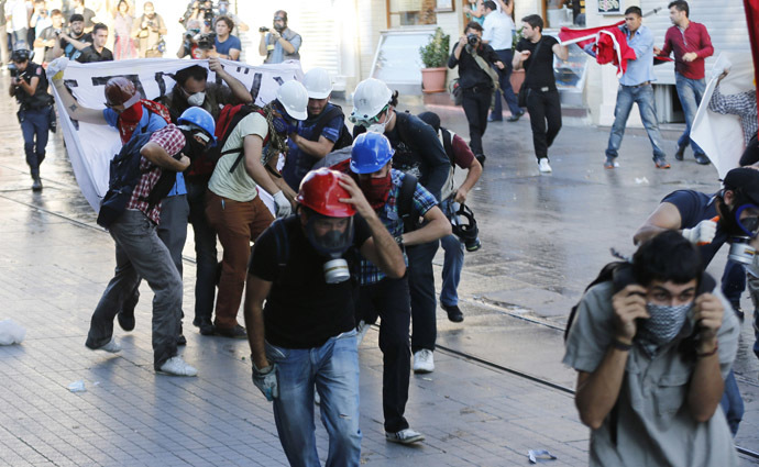 Demonstrators run as riot police use teargas and water cannon to disperse them during a protest at Taksim square in central Istanbul July 6, 2013. (Reuters/Murad Sezer)