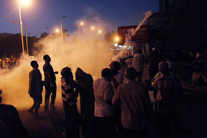 Tear gas fills the air as Egyptian supporters of the Muslim Brotherhood rallying in support of deposed president Mohamed Morsi clash with police outside the elite Republican Guards base in Cairo early on July 8, 2013 (AFP Photo / Mahmoud Khaled) 