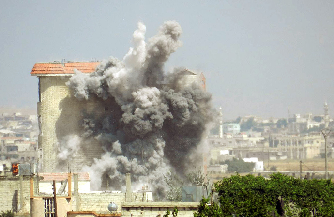 A handout picture released by the opposition-run Shaam News Network on June 2, 2013, shows smokes rising as a mortar shell hits a building in the town of al-Hula in the Syrian province of Homs during clashes between rebel forces and pro-government troops (AFP Photo / HO / Shaam News Network)