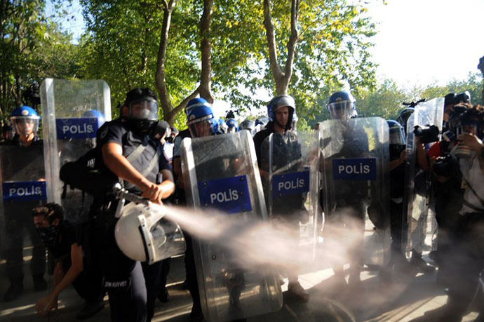 Turkish riot policemen use gas to disperse demonstrators at the Taksim Gezi Park on Istiklal Avenue in Istanbul on July 8, 2013. (AFP Photo / Bulent Kilic)