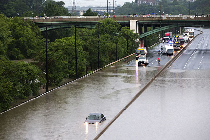 A car is stuck during a flood on the Don Valley Parkway, a major highway, during a heavy rainstorm in Toronto, July 8, 2013. (Reuters / Mark Blinch)