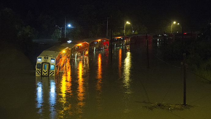 A Go Train, a commuter train, with passengers waiting to be rescued inside, is stuck in flood waters during a heavy rainstorm in Toronto, July 8, 2013. (Reuters / Mark Blinch)
