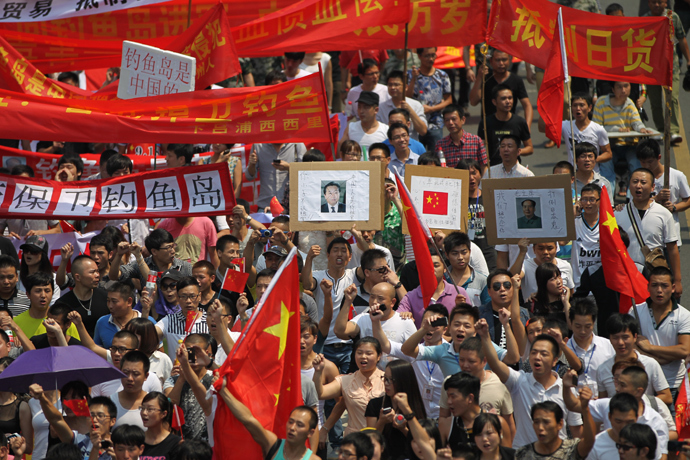 Chinese demonstrators carry Chinese national flags and shout slogans during a protest against Japan's "nationalizing" of the Diaoyu islands, also known as Senkaku in Japan, in Wenzhou, east China's Zhejiang province on September 18, 2012 (China out / AFP Photo) 