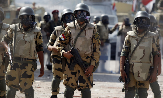 Army soldiers wear gas masks before clashes with members of the Muslim Brotherhood and supporters of deposed Egyptian President Mohamed Mursi at Republican Guard headquarters in Nasr City, a suburb of Cairo July 8, 2013 (Reuters / Amr Abdallah Dalsh)