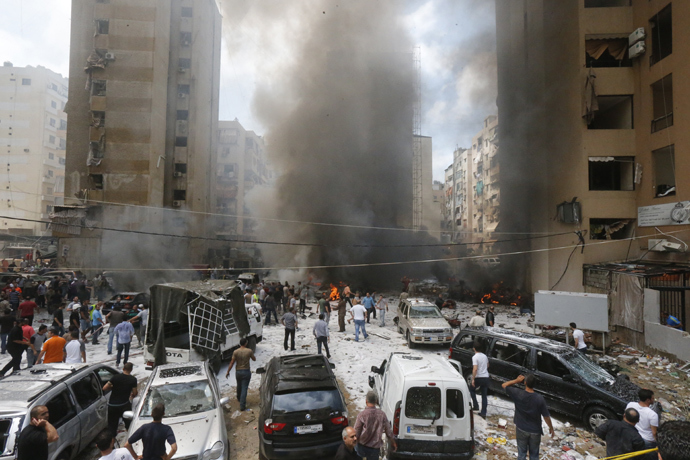 Firefighters and residents gather at the site of an explosion in Beirut's southern suburb neighbourhood of Bir al-Abed on July 9, 2013 (AFP Photo / Str) 