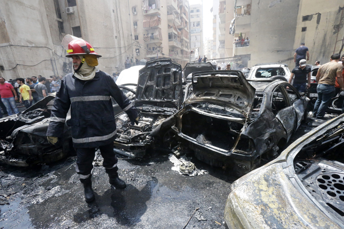A firefighter stands after extinguishing fire from vehicles at the site of an explosion in Beirut's southern suburb neighbourhood of Bir al-Abed on July 9, 2013 (AFP Photo / Str) 