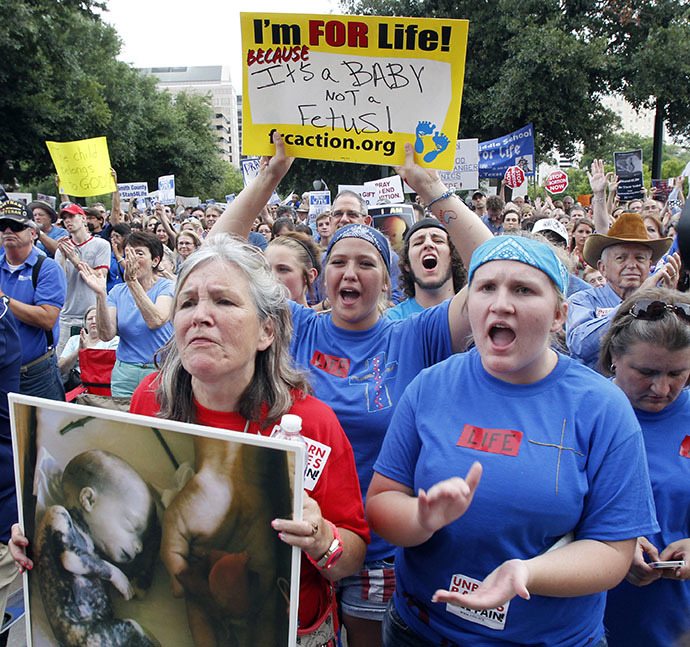 Protesters hold signs and shout during an anti-abortion rally at the State Capitol in Austin, Texas, July 8, 2013. (Reuters / Mike Stone)
