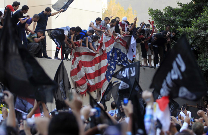 Protesters destroy an American flag pulled down from the U.S. embassy in Cairo September 11, 2012. (Reuters/Mohamed Abd El Ghany)
