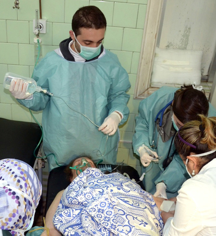 In this image made available by the Syrian News Agency (SANA) on March 19, 2013, medics check a woman at a hospital in the Khan al-Assal region in the northern Aleppo province, as Syria's government accused rebel forces of using chemical weapons for the first time. (AFP/SANA)
