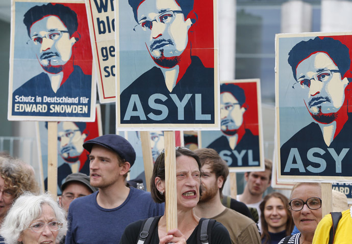 Demonstrators hold banner during protest rally in support of former U.S. spy agency NSA contractor Edward Snowden in Berlin July 4, 2013. (Reuters/Tobias Schwarz)
