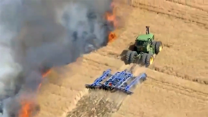 Farmer risks his life to stop wildfire with tractor (VIDEO)