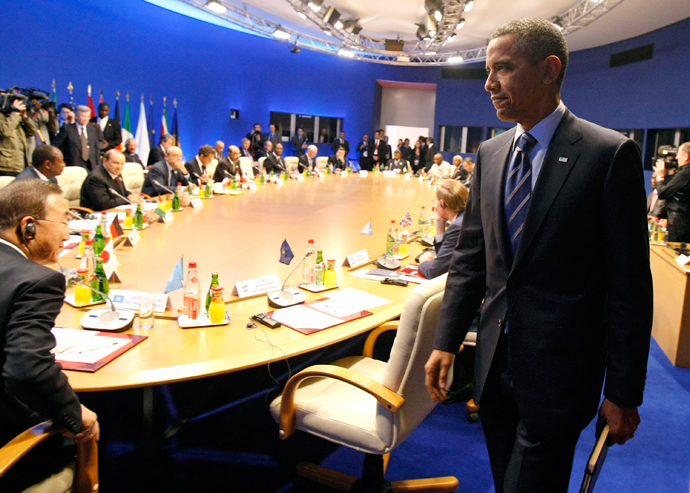 U.S. President Barack Obama prepares to take his seat for a round table meeting G8 members (Reuters / Remy De La Mauviniere)