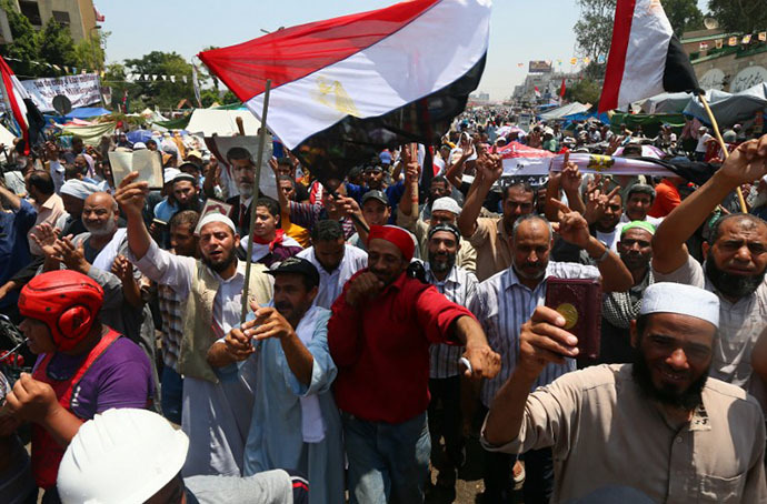 Supporters of Egypt's deposed president Mohamed Morsi chant islamic slogans during a rally outside Cairo's Rabaa al-Adawiya mosque on July 13, 2013. (AFP Photo / Marwan Naamani)