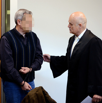 German (codenamed) Andreas Anschlag talks to his lawyer at court on January 15, 2013 in Stuttgart, southern Germany (AFP Photo)