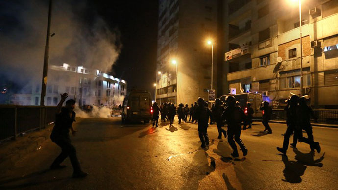 Egyptian riot police disperse supporters of the Muslim Brotherhood and Egypt's ousted President Mohamed Morsi block on July 16, 2013 near the Six October bridge in the center of Cairo. (AFP photo / Marwan Naamani)