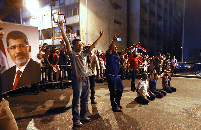 A supporter of the Muslim Brotherhood and Egypt's ousted President Mohamed Morsi block the Six October bridge on July 16, 2013 in the center of Cairo. (AFP Photo / Marwan Naamani)