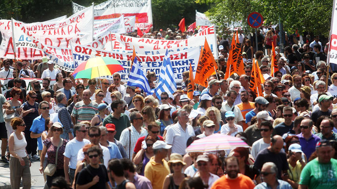 Protestors march during a general strike called by Greek public and private employee unions GSEE and ADEDY to protest against fresh austerity measures the government is imposing in order to keep receiving EU-IMF loansin Thessaloniki on July 16, 2013.(AFP Photo / Sakis Mitrolidis)