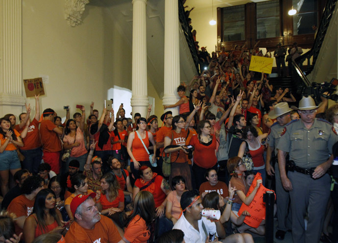 Abortion rights protesters rally inside the State Capitol after the state Senate passed legislation restricting abortion rights in Austin, Texas, July 13, 2013. (Reuters/Mike Stone)