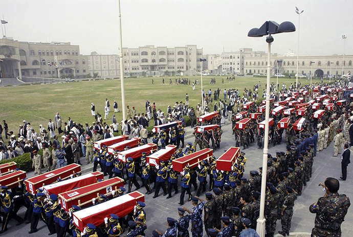 Soldiers carry coffins during the funeral of dozens of soldiers killed in Monday's suicide bombing in Sanaa May 24, 2012. (Reuters)