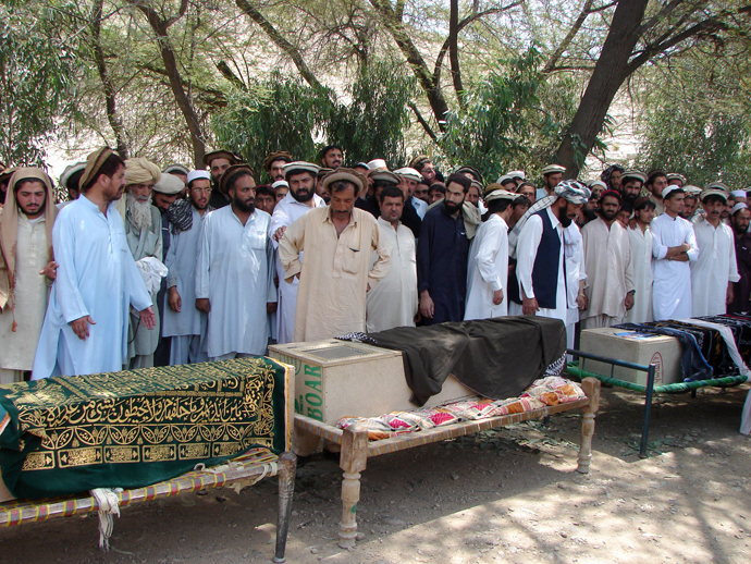 Pakistani tribesmen gather for funeral prayers before the coffins of people allegedly killed in a US drone attack, claiming that innocent civilians were killed during a June 15 strike in the North Waziristan village of Tapi, 10 kilometers away from Miranshah, on June 16, 2011 (AFP Photo)