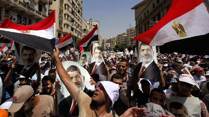 Clashes, helicopters, tear gas as tens of thousands take to streets of Egypt