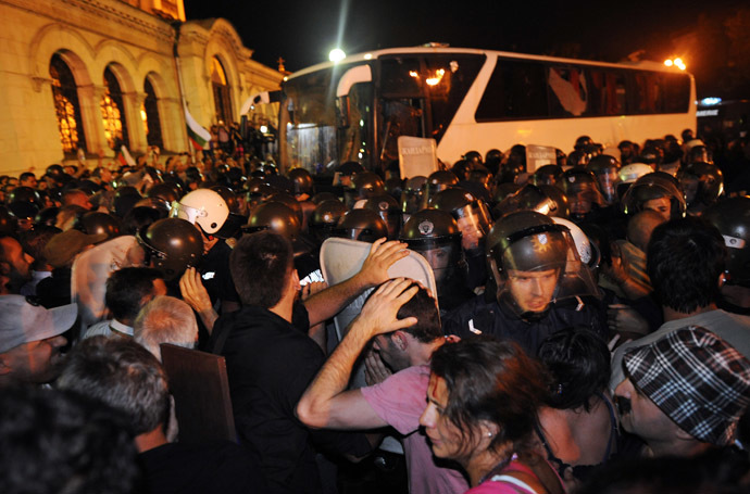 Bulgarian riot policemen push protestors back to make way for lawmakers and parliament staff driven in a bus during an anti-government protest in Sofia on July 23, 2013. (AFP Photo/Dimitar Dilkoff)