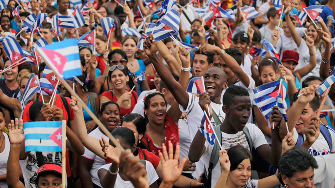 People wave flags during the May Day parade in Havana's Revolution Square May 1, 2013.(Reuters / Desmond Boylan)