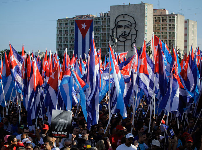 People carry Cuban flags at the May Day parade in Havana's Revolution Square May 1, 2012.(Reuters / Desmond Boylan)