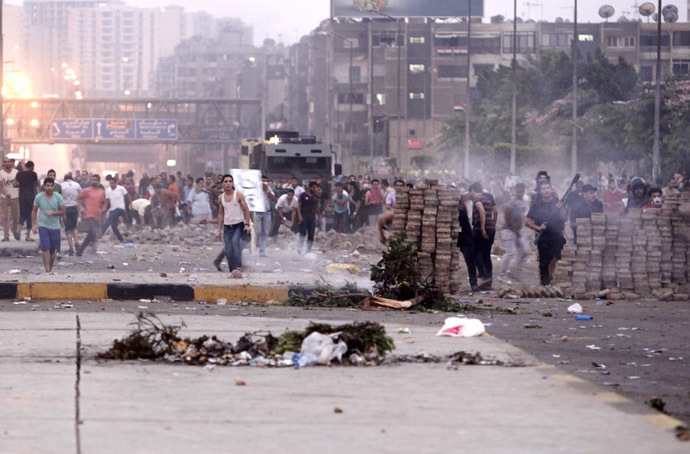Opponents of deposed Egyptian President Mohamed Mursi throw stones at his supporters during clashes in Nasr city area, east of Cairo July 27, 2013. (Reuters/Asmaa Waguih)