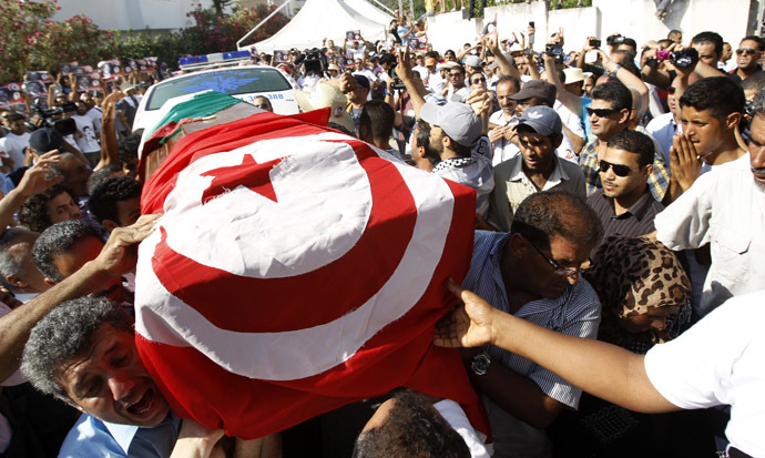 Mourners carry the coffin of slain opposition leader Mohamed Brahmi during his funeral procession towards the nearby cemetery of El-Jellaz, where he is to be buried, in Tunis July 27, 2013. (Reuters/Zoubeir Souissi)