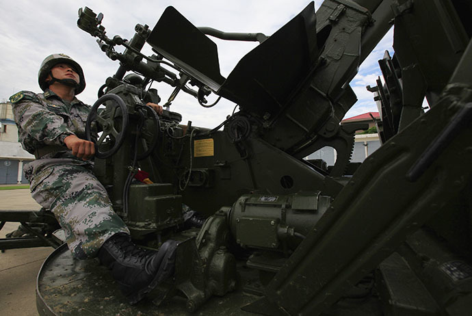 A soldier from Air Defence Brigade, 47th Combined Corps, PLA poses for picture during a display organized for media by Chinese government in Lintong, Shaanxi province July 29, 2013. (Reuters / Petar Kujundzic)