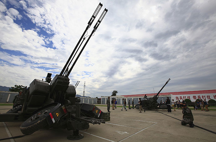 A soldier from Air Defence Brigade, 47th Combined Corps, PLA takes pictures during a display organized for media by Chinese government in Lintong, Shaanxi province July 29, 2013. (Reuters / Petar Kujundzic)