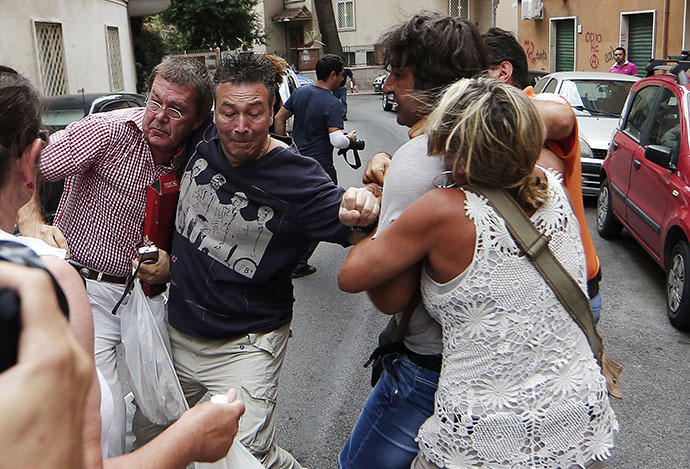 Protesters react against a relative of convicted former Nazi SS captain Erich Priebke during a protest in front of his residence in Rome July 29, 2013. (Reuters)