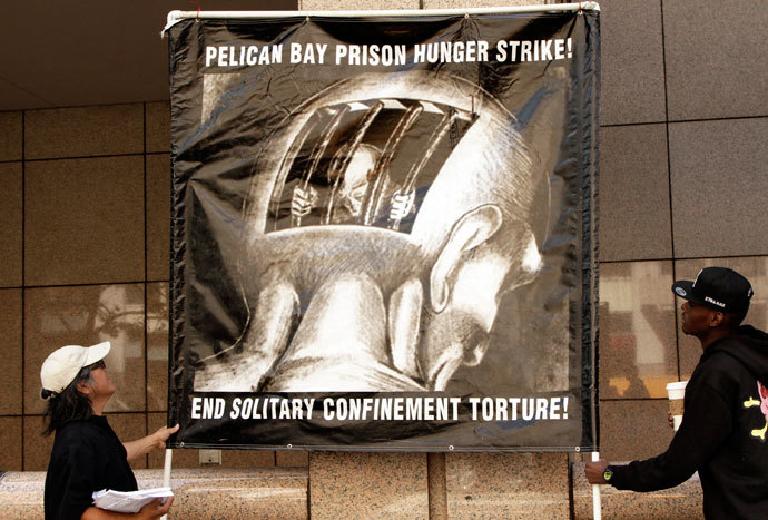 Men hold up a sign during a rally supporting hunger strikers in the California prison system in Los Angeles, California July 29, 2013. (Reuters / Jonathan Alcorn)