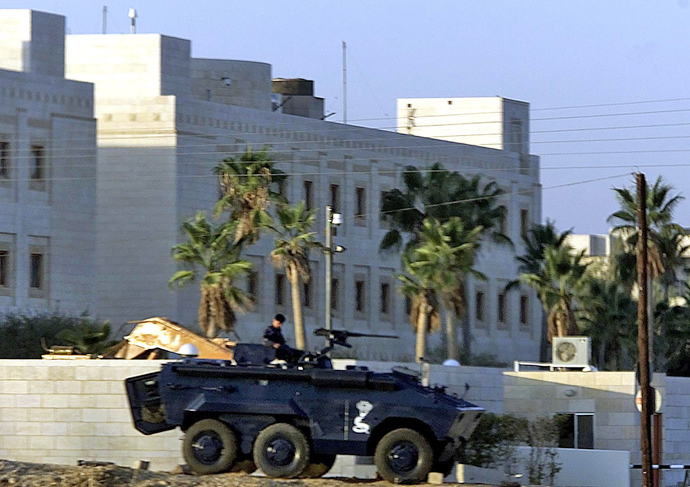 Jordanian policeman sits on the top of an Armoured Personal Carrier (APC) in front of U.S. embassy in Amman (Reuters / Goran Tomasevic)