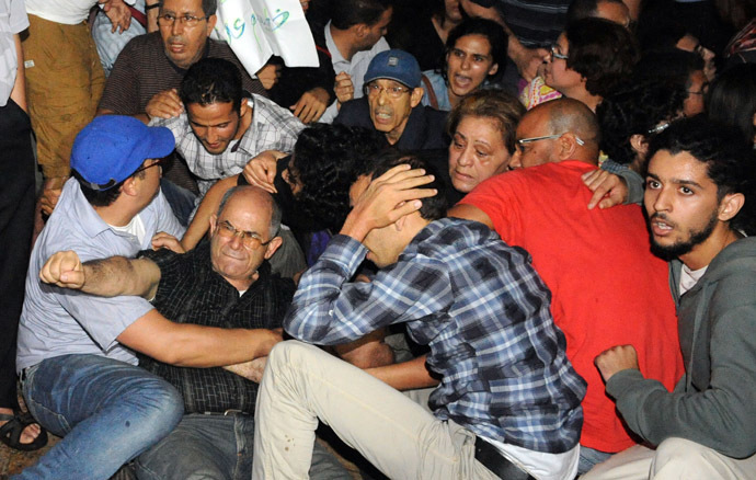 Angry protesters stage a demonstration on August 2, 2013 in Rabat-Morocco to protest the release of a Spanish paedophile, Daniel Fino Galvan who raped 11 local children was pardoned by the Moroccan King Mohammed VI. (AFP Photo/Fadel Senna)