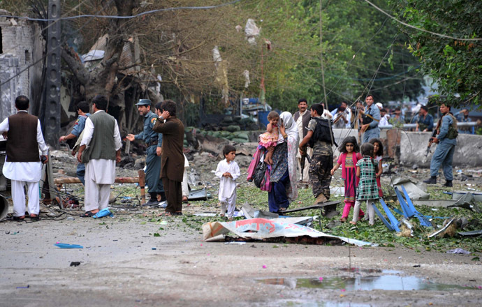 Afghanistan policemen and civilians walk at the siTe of a suicide attack in front of the Indian consulate in Jalalabad on August 3, 2013. (AFP Photo/Noorullah Shirzada) 