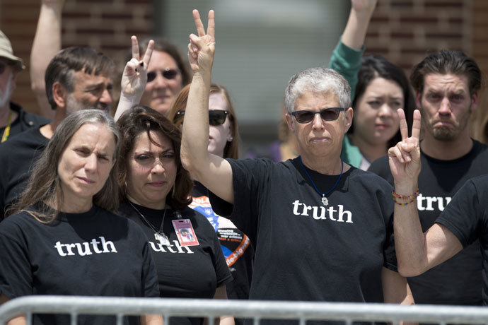 Supporters of US Army Private First Class Bradley Manning gesture peace signs after attending the trial where Manning was read his verdict in the trial at a military court at Fort Meade, Maryland on July 30, 2013.(AFP Photo / Saul Loeb)