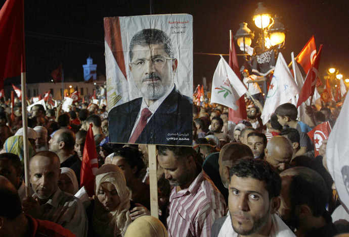 Supporters of the Islamist Ennahda movement hold a portrait of ousted Egyptian President Mohamed Morsi during a demonstration at Kasbah Square in Tunis August 3, 2013. (Reuters/Zoubeir Souissi)
