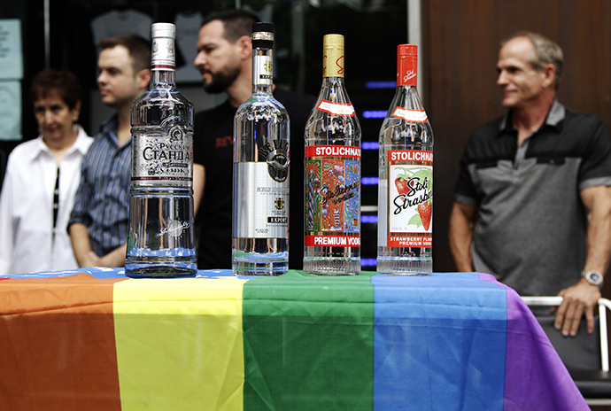 Bottles of Russian vodka are placed on an LGBT-themed American flag during a news conference in West Hollywood (Reuters / Jonathan Alcorn)