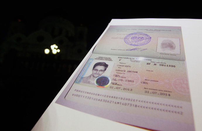 Fugitive former U.S. spy agency contractor Edward Snowden's new refugee documents granted by Russia is seen during a news conference in Moscow August 1, 2013 (Reuters / Maxim Shemetov)